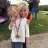 A young girl holding onto a medal in her hand.